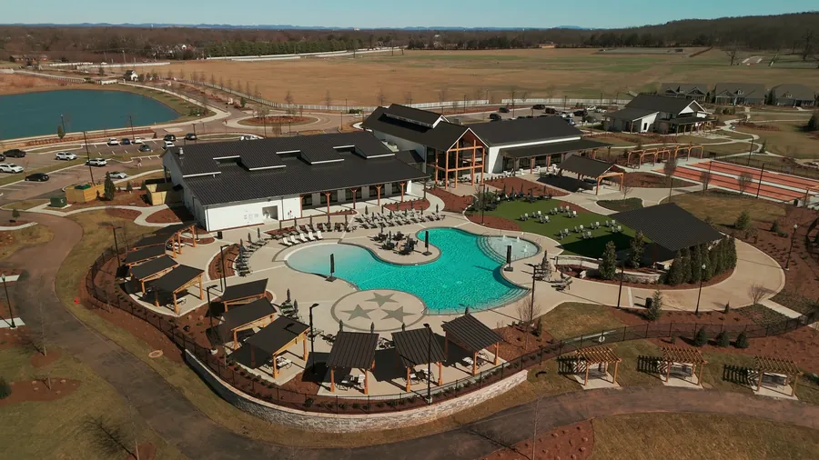 Aerial drone view of the Southern Harmony clubhouse and pool, grand opening video — click to play