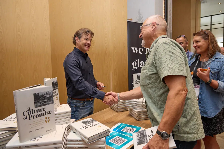 Author greeting an attendee at a book signing at ECRS Ignite 2026