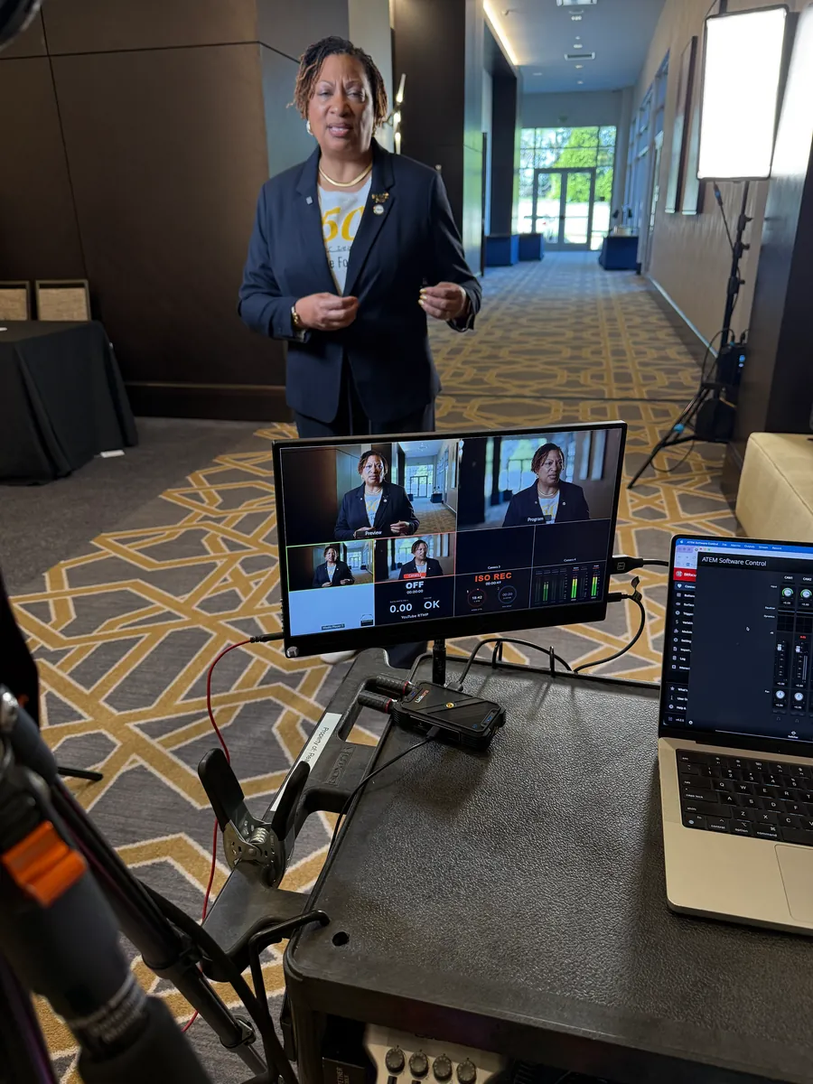 Conference speaker recorded with a multi-camera switcher setup on a laptop