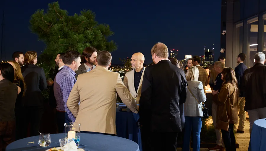 Crowd on the rooftop at night at the Frazier & Deeter Nashville open house