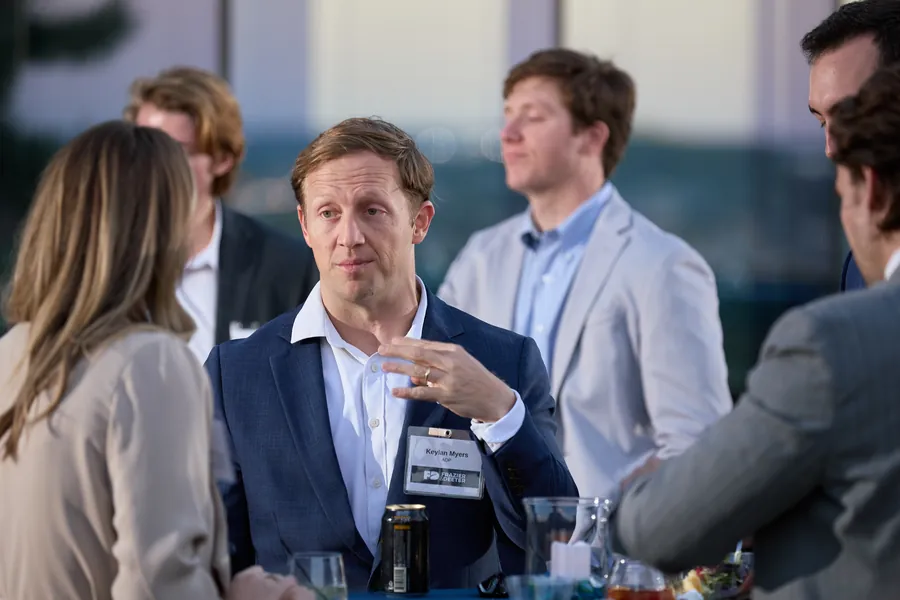 Guests talking around a table at the Frazier & Deeter Nashville open house