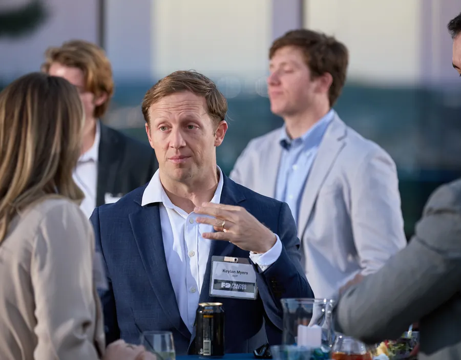 Guests talking around a table at the Frazier & Deeter Nashville open house