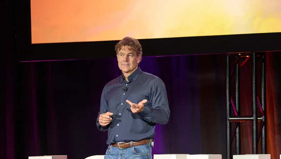 Keynote speaker in front of the giant IGNITE letters at ECRS Ignite 2026