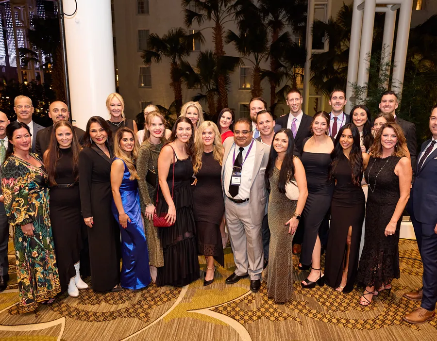 Large group photo of conference attendees in formal wear