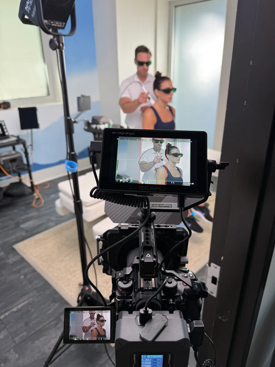 Live streaming setup with an on-camera director's monitor, crew member watching playback