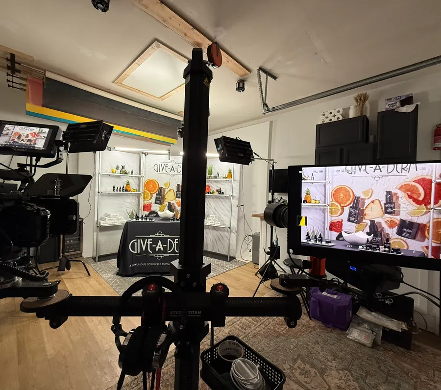 On-camera brand video shoot for Give-A-Derm with a monitor and product shelf backdrop
