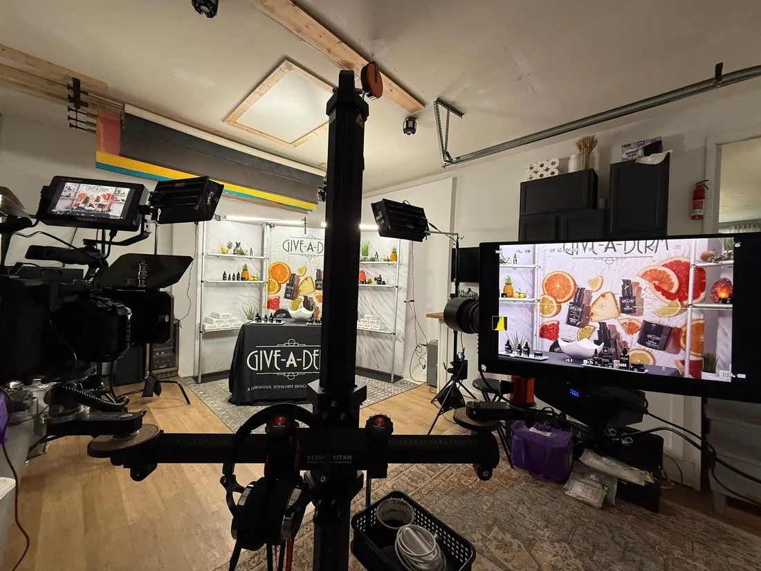 On-camera brand video shoot for Give-A-Derm, with a monitor showing the live feed against a product shelf backdrop — click to play