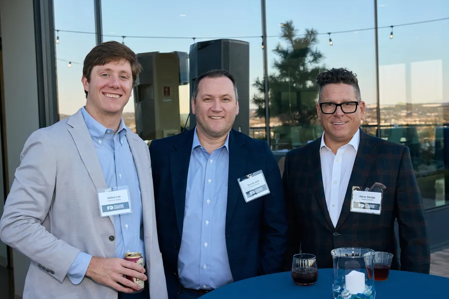 Three men posing on the rooftop at golden hour, Frazier & Deeter Nashville open house