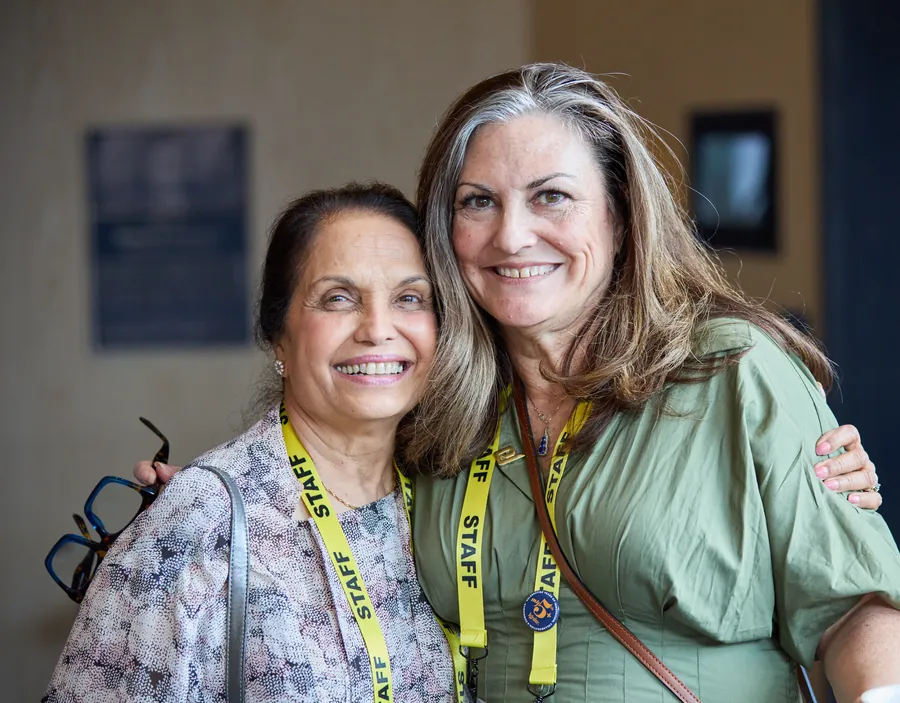 Two conference staff members smiling together at ECRS Ignite 2026