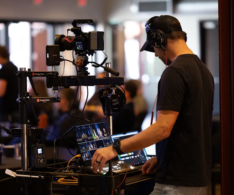 Video crew operating a handheld gimbal camera rig indoors