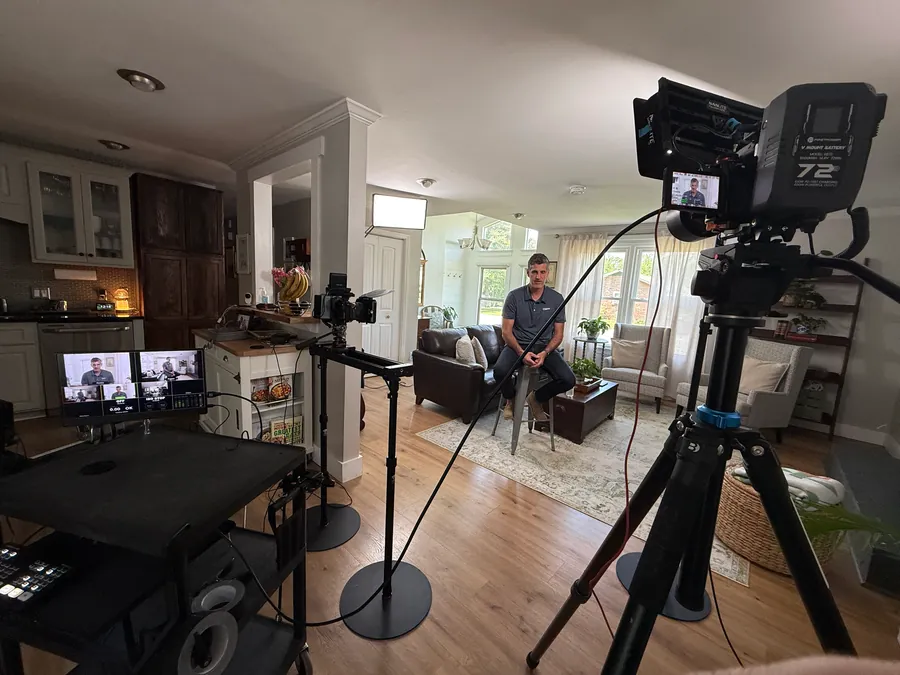 Wide view of a podcast and interview recording set styled as a living room