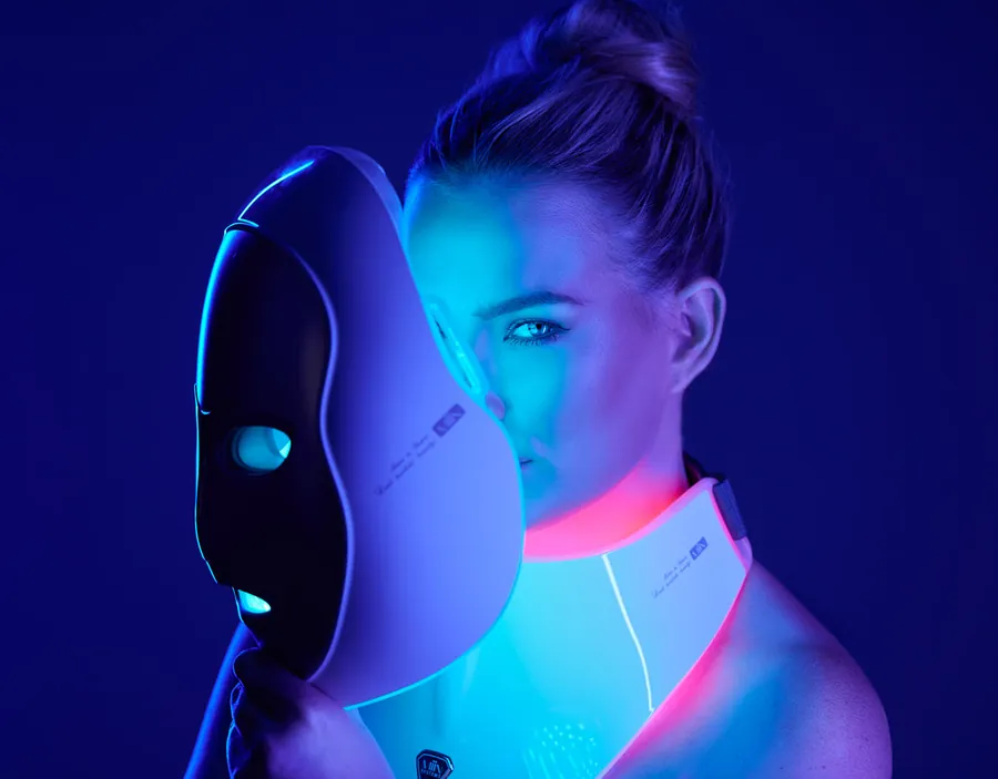 Woman with an LED mask against a deep blue background, Artemis campaign