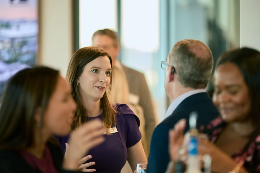 Women chatting by the windows at the Frazier & Deeter Nashville open house